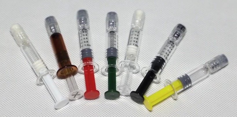Image of colorful plastic plunger syringe
