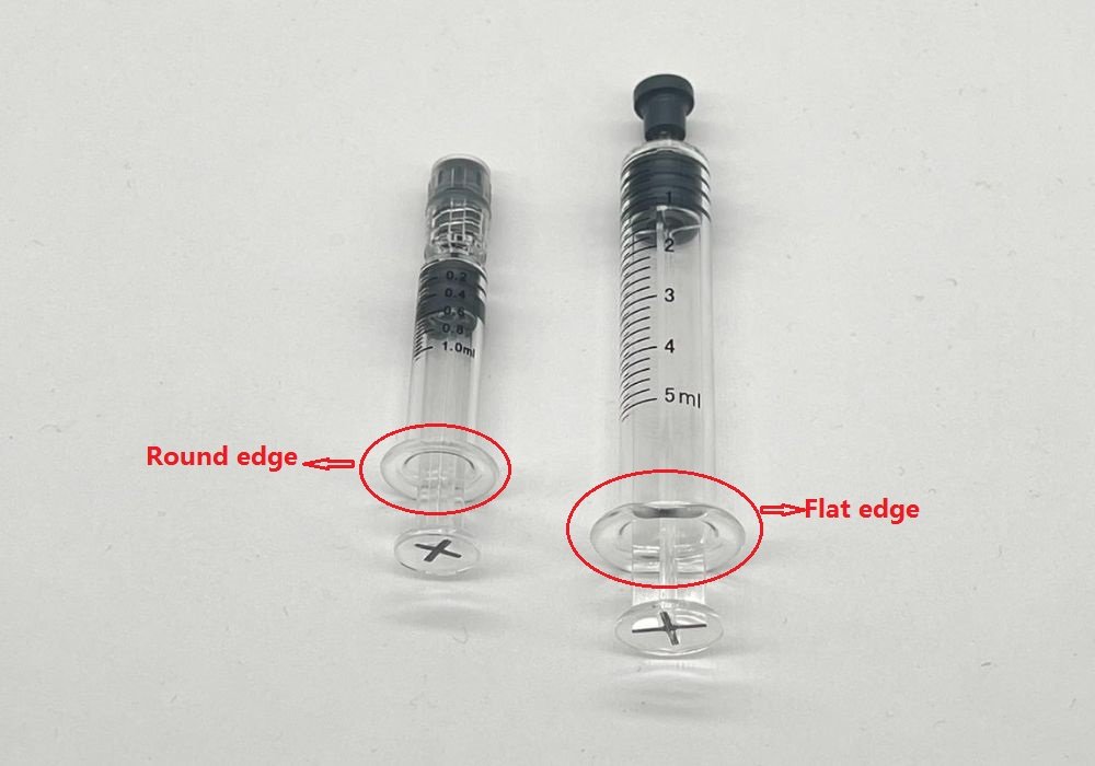 picture of 1ml round edge syringe and 5ml flat edge syringe