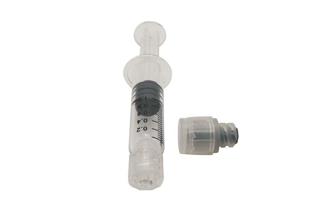 image of cannabis oil syringe with a CR cap
